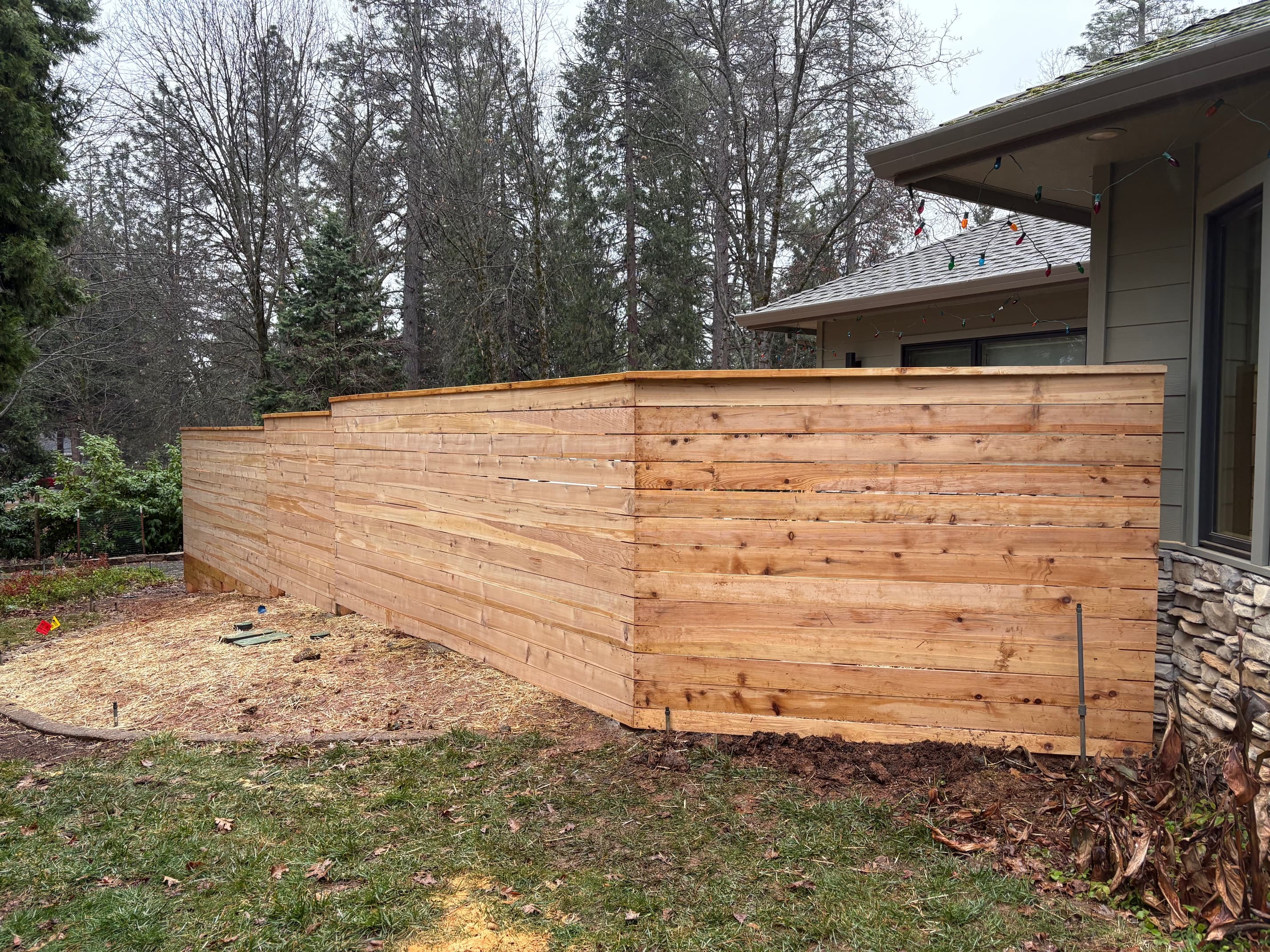 Cedar horizontal fence along side of house, winter