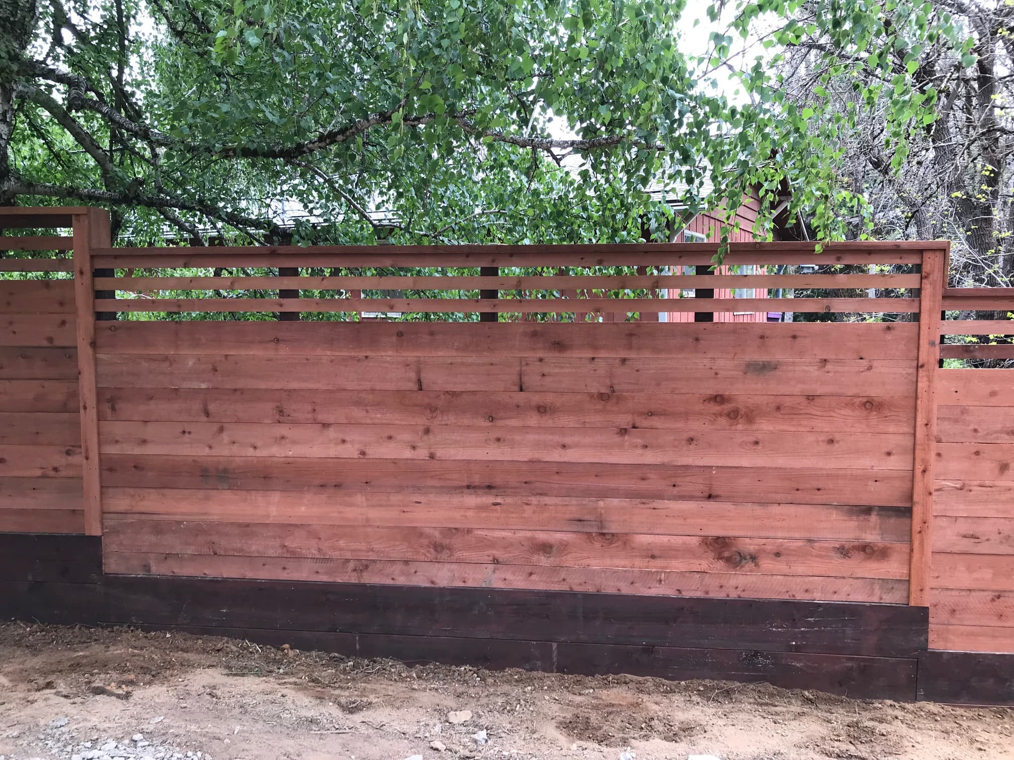 Close-up of redwood horizontal fence with slatted top